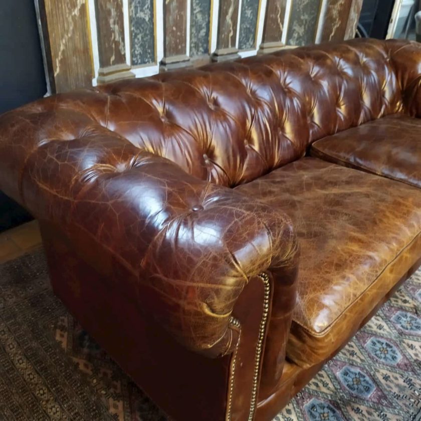Brown leather Chesterfield sofa armrest