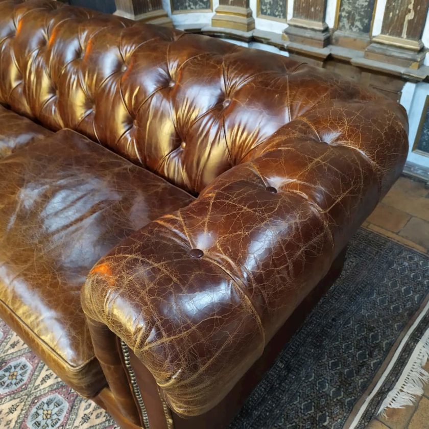 Brown leather Chesterfield sofa armrest
