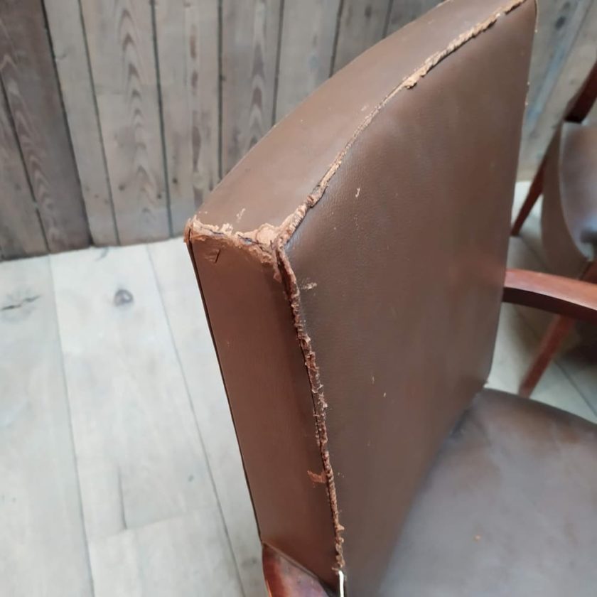 worn brown leather armchair