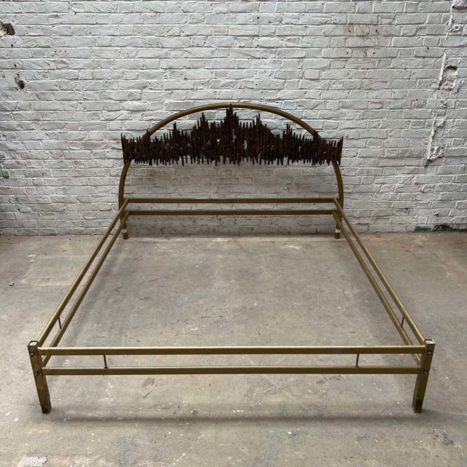 Bed with bronze top headboard