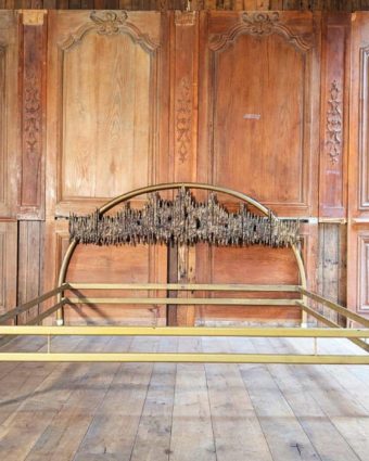Bed with front bronze headboard