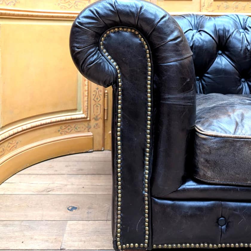 Antique Chesterfield in black leather side 1