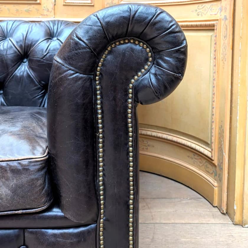 Antique Chesterfield in black leather side