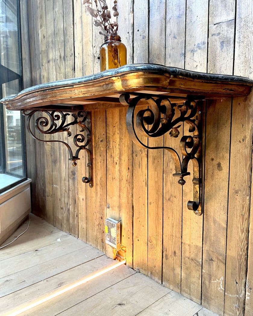 Pair of black marble and iron console tables