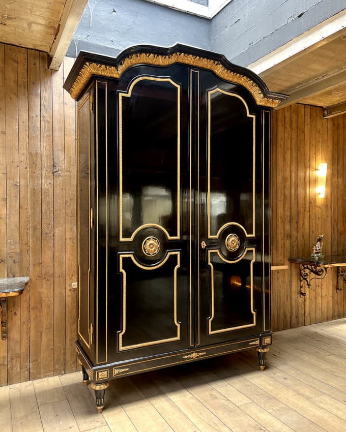 Large cabinet in blackened wood and gilded wood