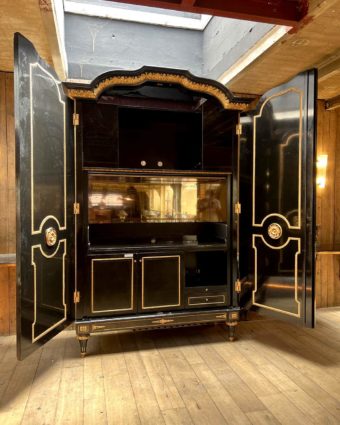Large cabinet in blackened wood and gilded wood