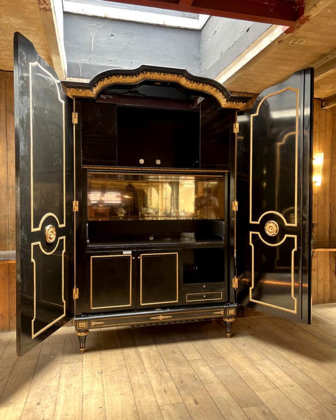 Large cabinet in blackened wood and gilded wood