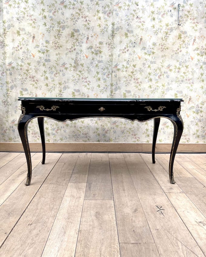 Bureau plat en bois noirci et doré de forme mouvementée