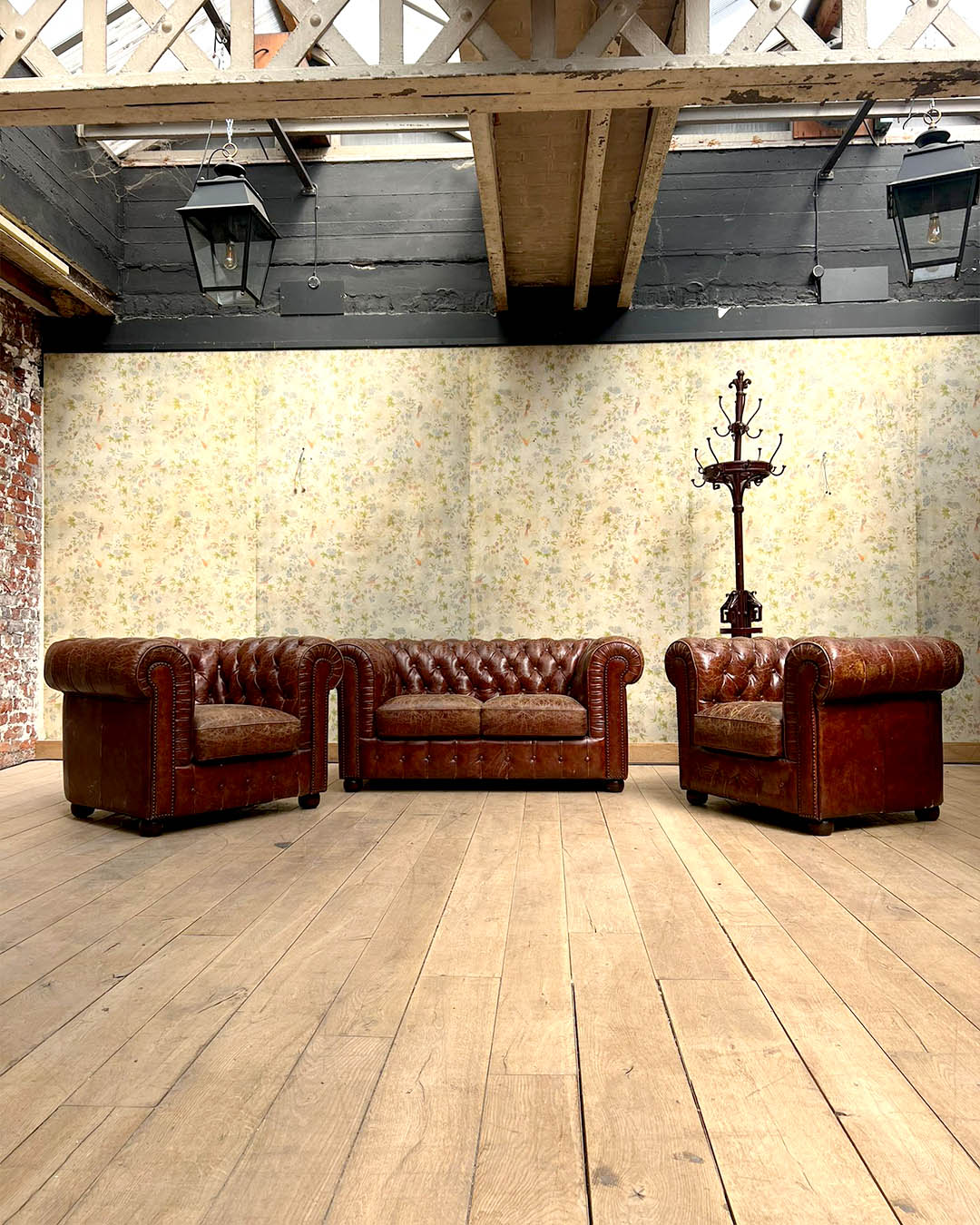 Salon chesterfield avec un canapé et deux fauteuils